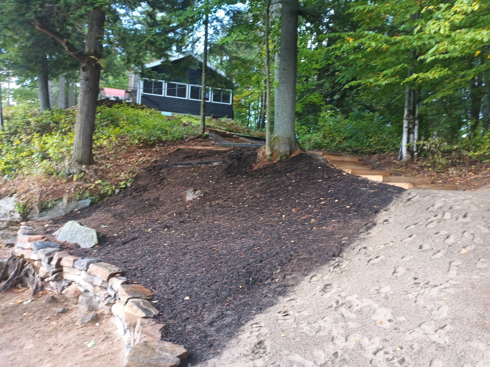 Bowl area prepared for planting — Triple Mix added, stone wall framing the lower edge